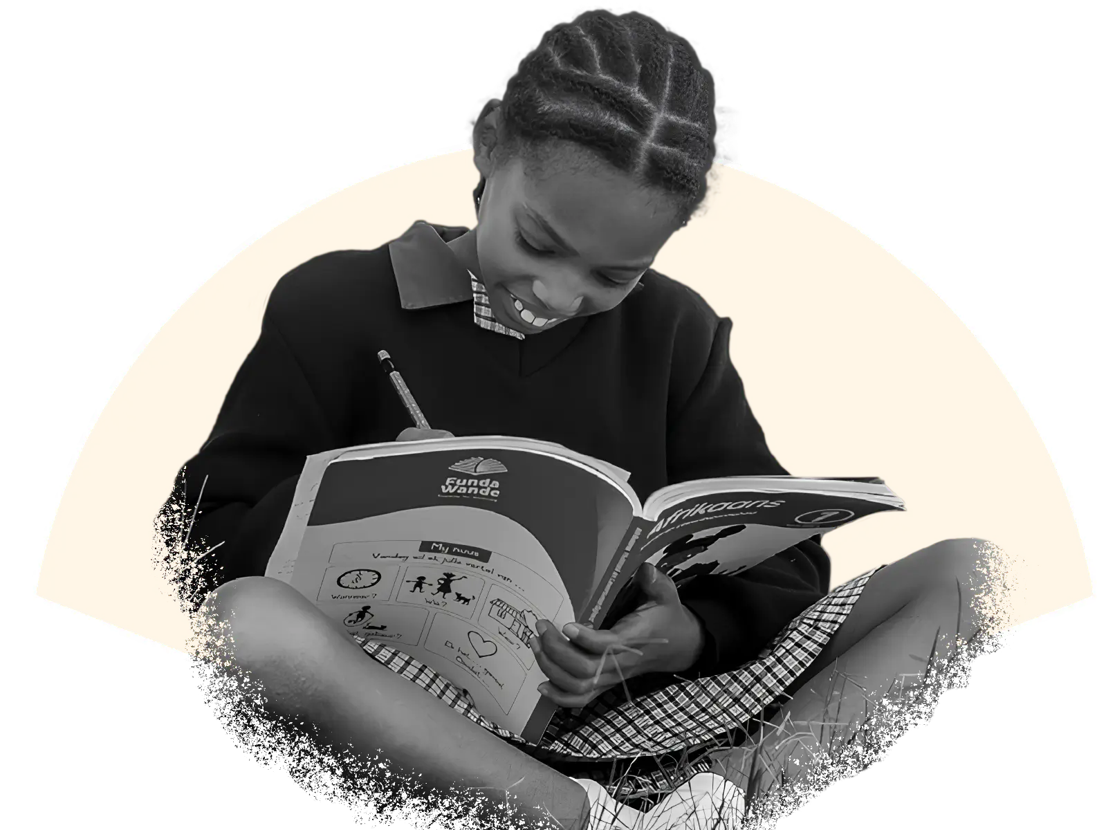 Primary school learner in uniform working in a literacy work book.